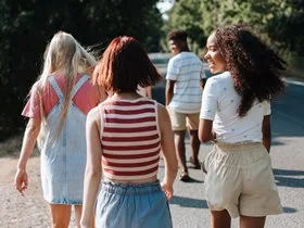 Group of school leavers walking along the side of the road